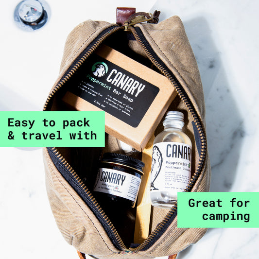 Toiletry bag showing Canary Toothpaste Tablets, Mouthwash Concentrate, and our Bar Soap