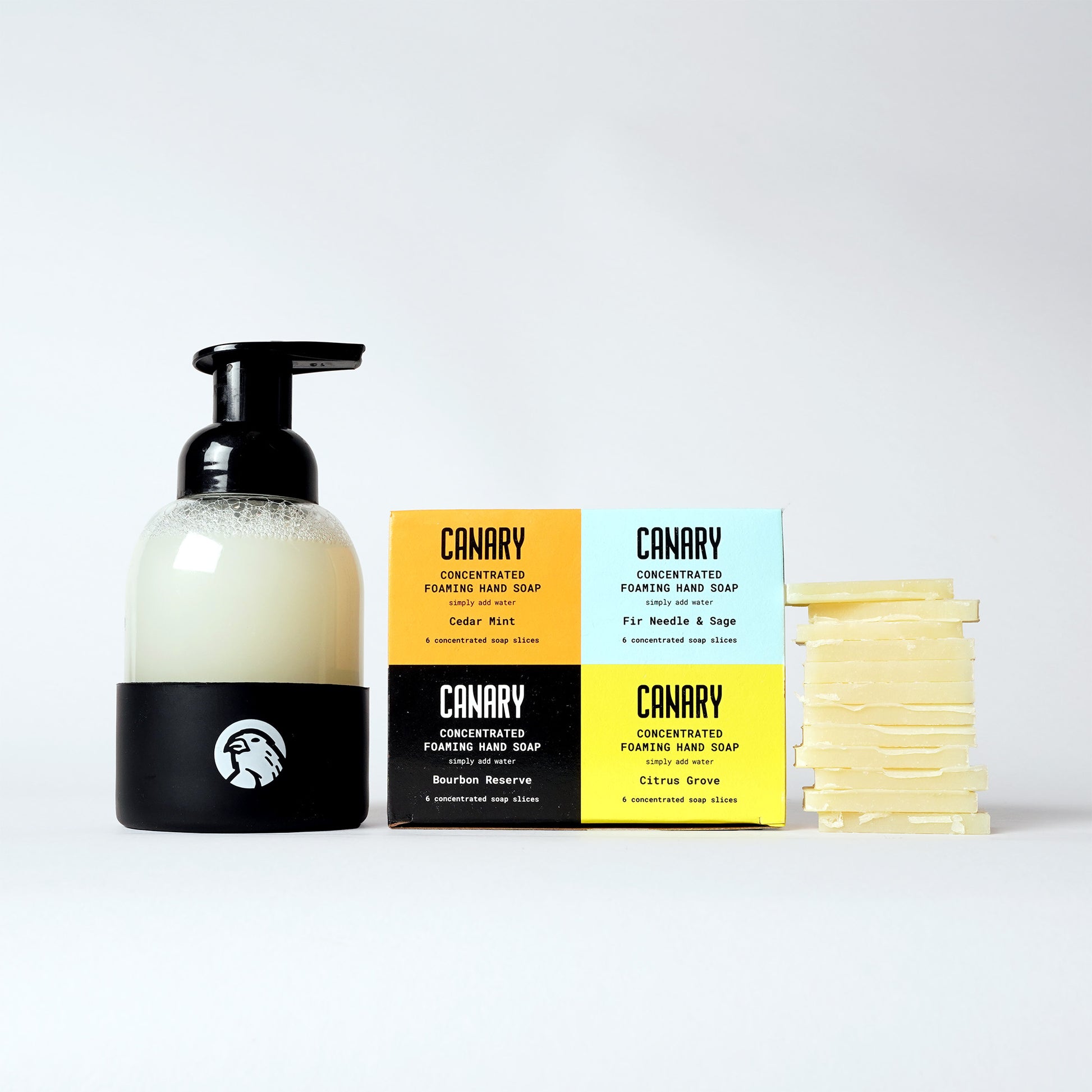 Front Image of Concentrated Foaming Hand Soap Gift Pack. 24 soap slices. 6 slices each of Cedar Mint, Fir Needle and Sage, Bourbon Reserve, and Citrus Grove. Eco-Friendly Refillable Glass Soap Bottle and 12 Soap slices next to product.